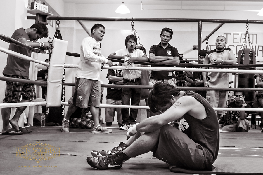 Manila, Philippines - World Boxing Champion and Congressman Manny 'Pacman' Pacquiao pauses in prayer at the conclusion work-out. Recently, Pacquiao became very religious and has changed his old ways. He is often seen preaching at Bible studies and quoting bible passages during media interviews. Pacquaio begins his training at MP Tower gym in Manila on April 17, 2012 in preparation for his fight against American boxing champion Timothy Bradley in Las Vegas on June 9, 2012. The MP Tower gym, a six-level building located in the outskirts of Manila is used to be the old L&M Gym, where Pacquaio first trained as a boxer when he was 17 years-old.  Photo by Ron Soliman