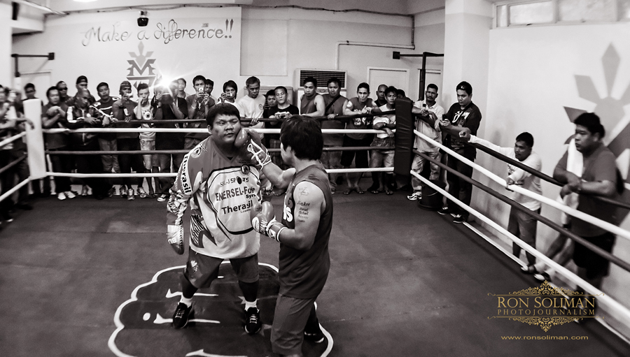 Manila, Philippines Childhood friend and assistant trainer Buboy Fernandez (left) receives a punch from World Boxing Champion and Congressman Manny 'Pacman' Pacquiao as he trains at the MP Tower gym in Manila on April 17, 2012 in preparation for his fight against American boxing champion Timothy Bradley in Las Vegas on June 9, 2012. The MP Tower gym, a six-level building located in the outskirts of Manila is used to be the old L&M Gym, where Pacquaio first trained as a boxer when he was 17 years-old.  Photo by Ron Soliman
